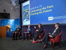 NIDCR leaders sitting on stage at a 75th Anniversary event.