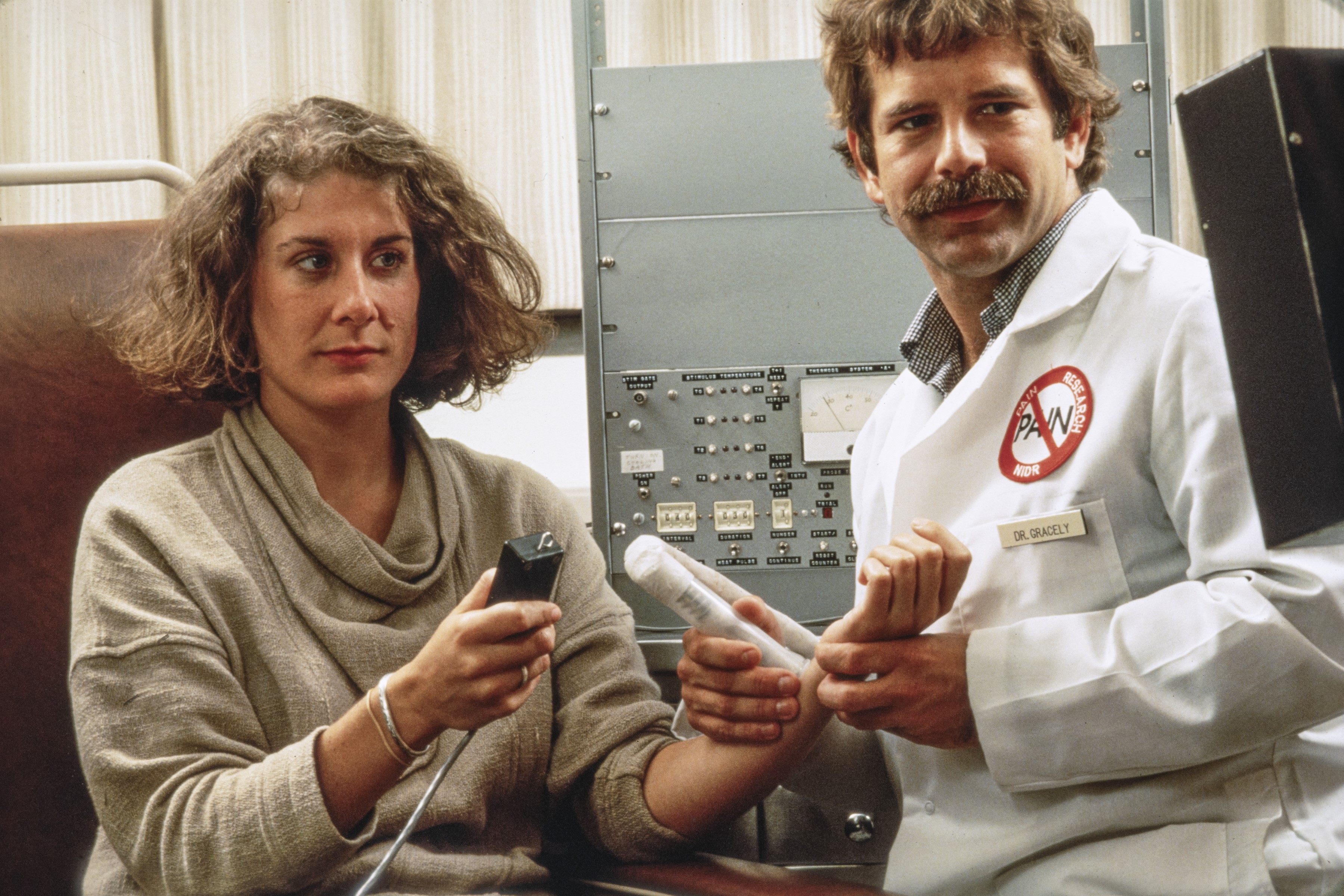 Richard Gracely working with a woman while observing the results on a monitor.