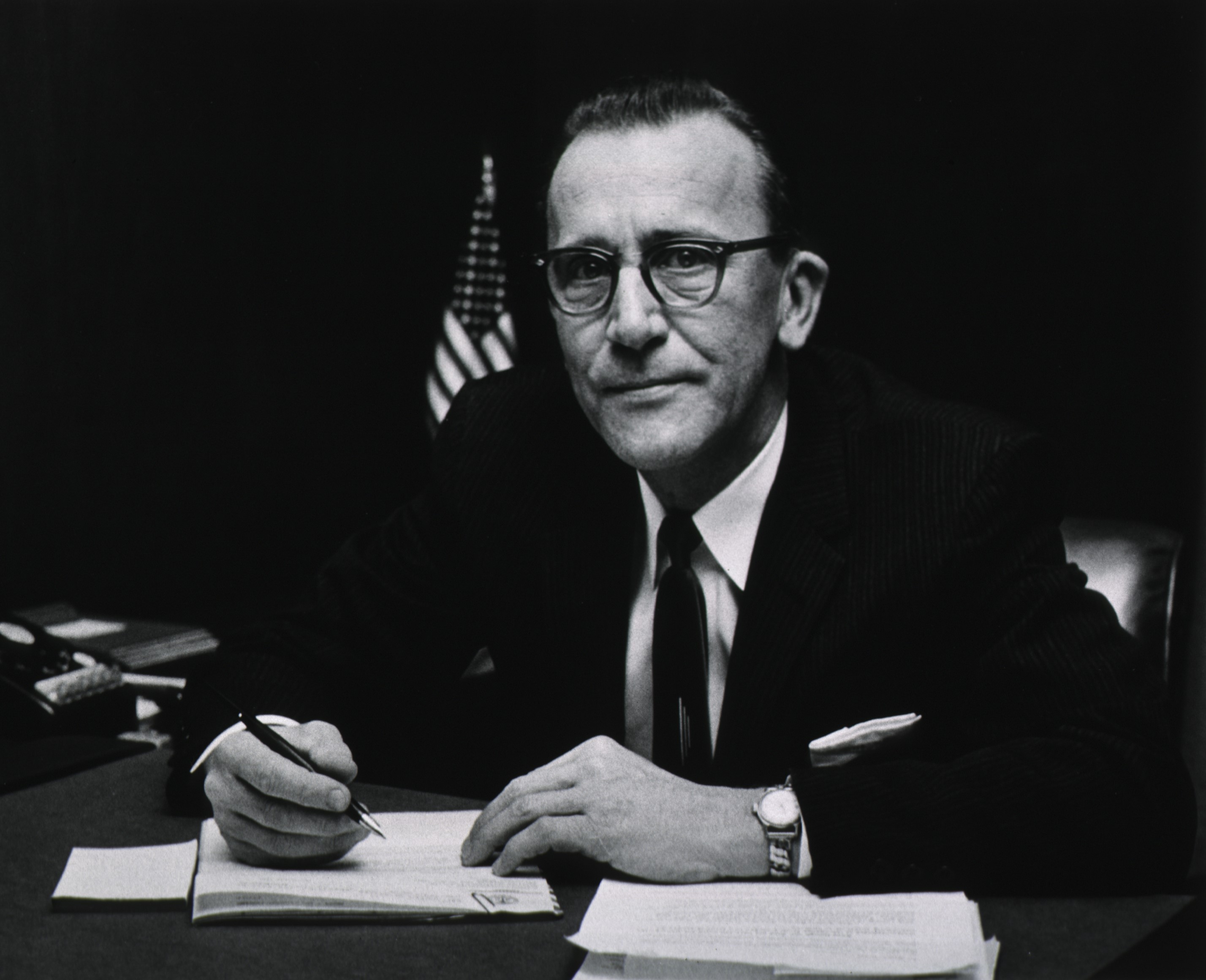 Francis Arnold signing documents. 