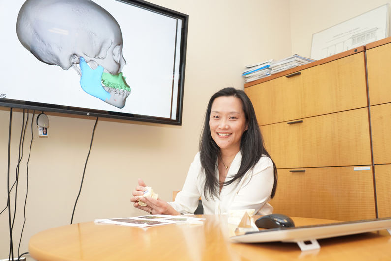 NIDCR Clinical Director Janice Lee sitting at desk 