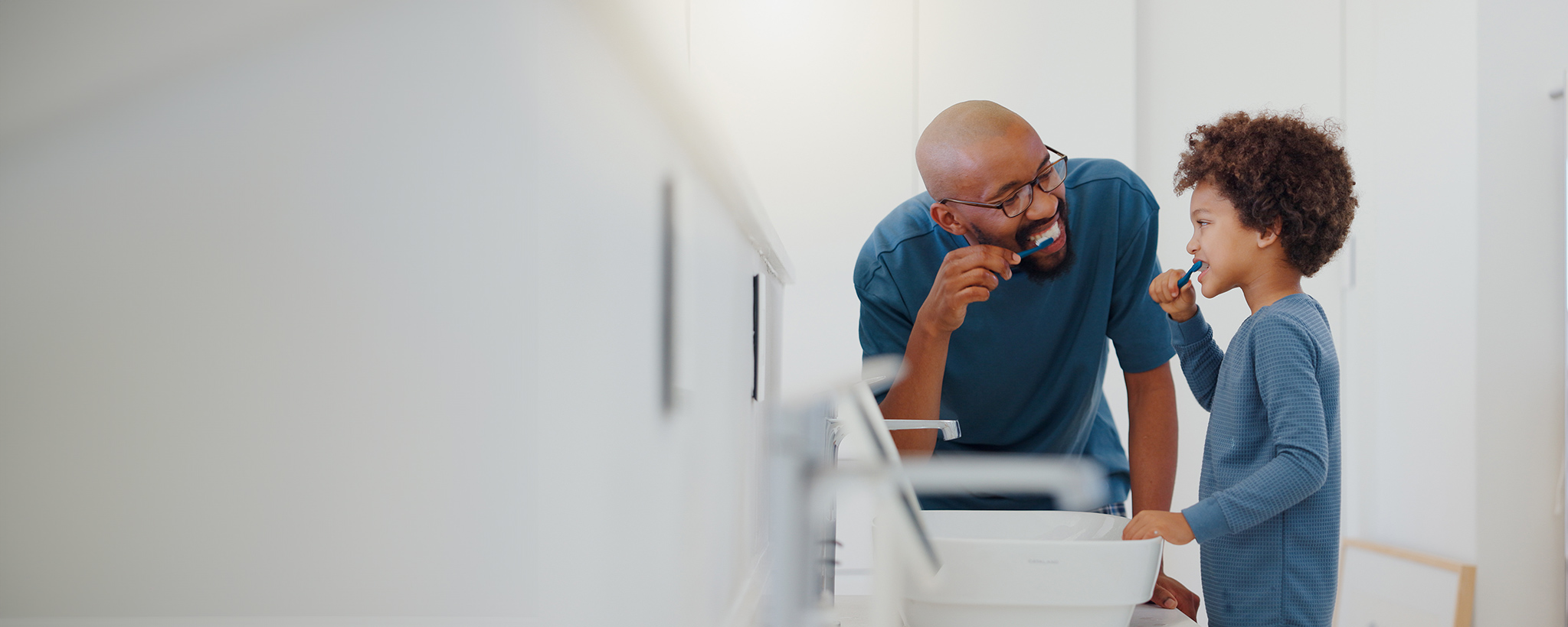 Dad and son brushing their teeth