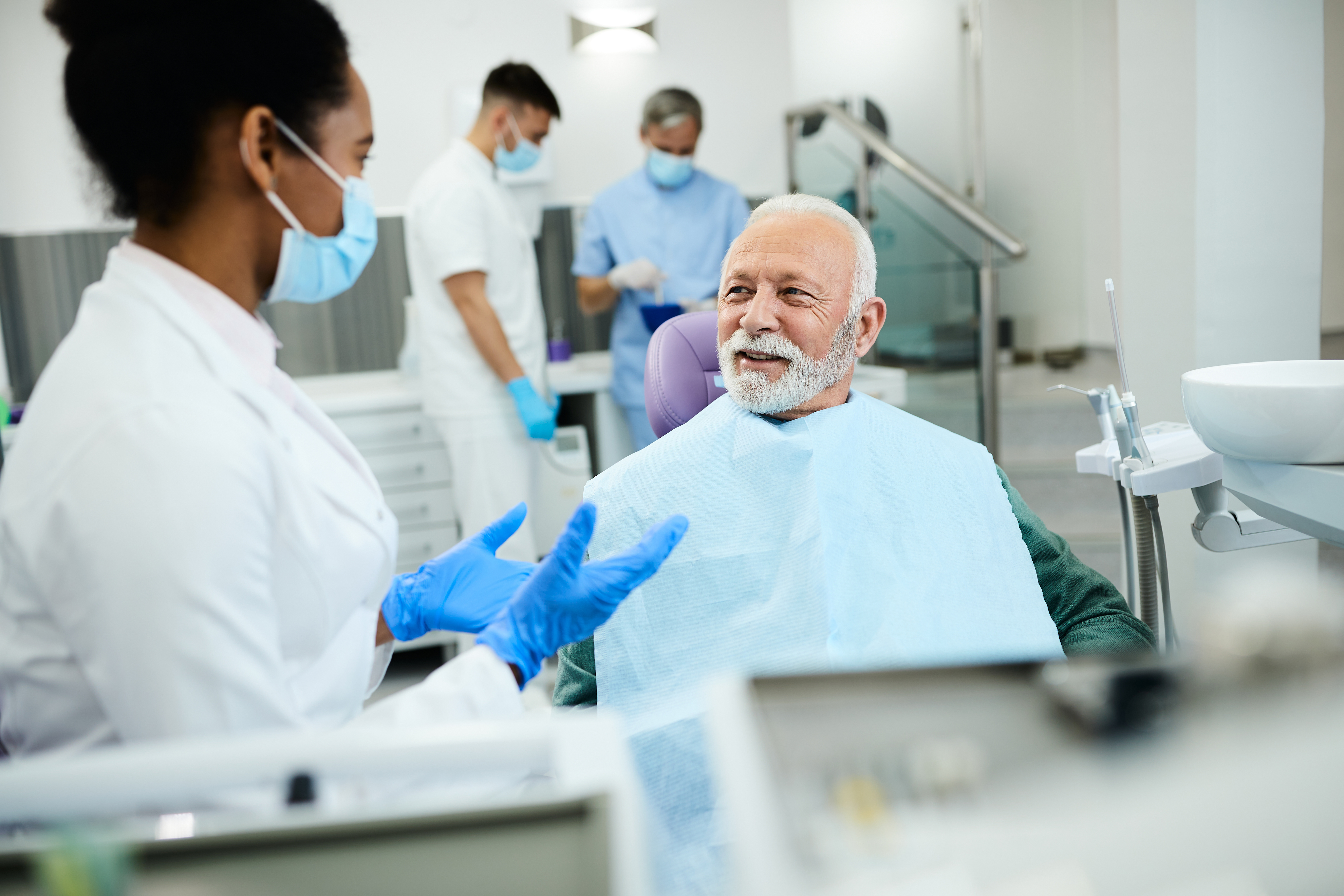 A person in a chair with their dentist.