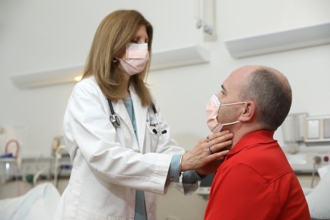 Photo of NIDCR senior research physician Rachel I. Gafni, MD, examining a clinical trial participant.