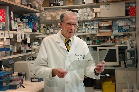 Abner Notkins working in a laboratory.