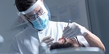 Doctor performing a dental procedure on a patient