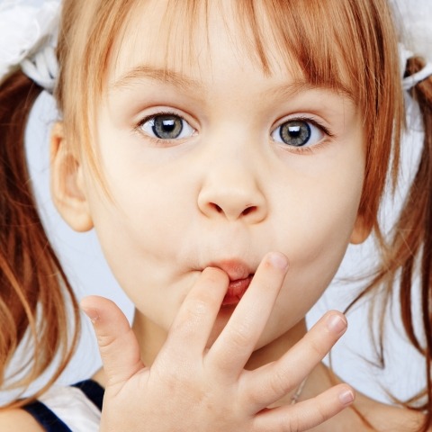 Young girl with finger in mouth