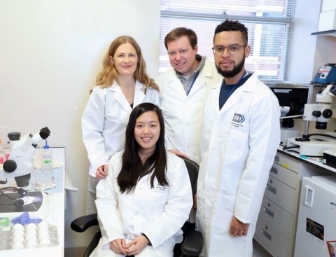 Four researchers smiling 