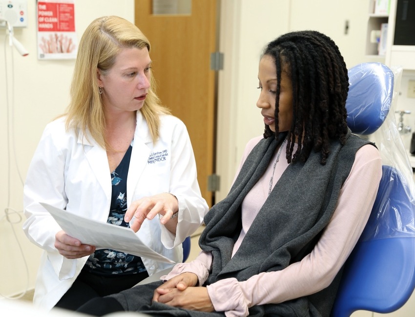 Clinical researcher consulting with a patient