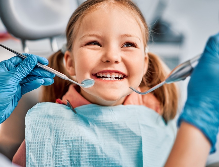 Little girl with a smile at the dentist.