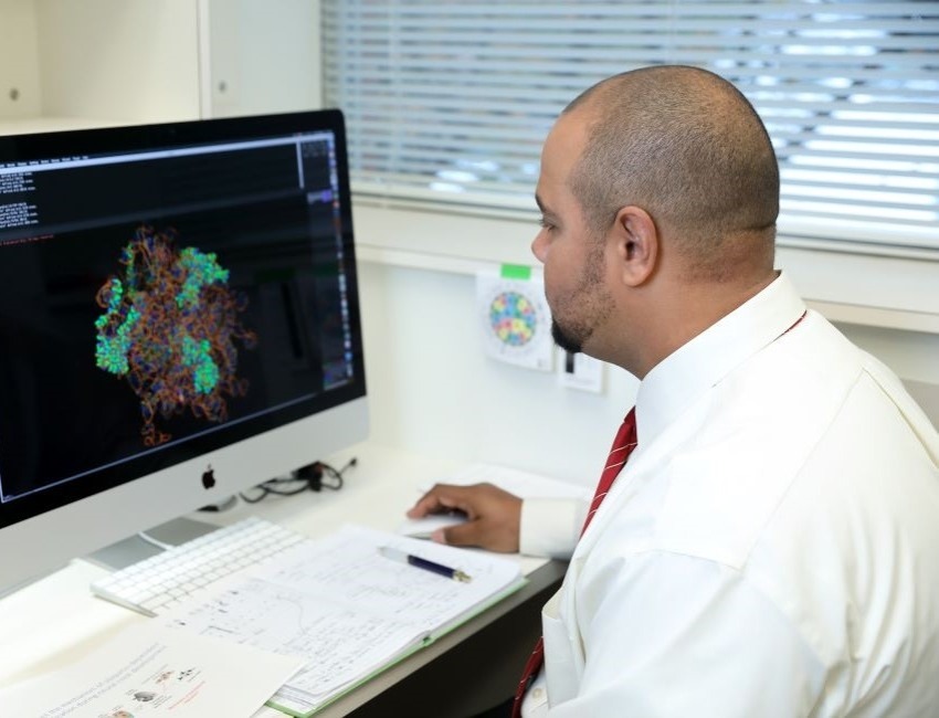 A person is sitting at a computer.