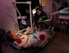 USC scientists developed a sensory adapted dental environment that featured dim lights, a weighted wrap, calm music, and image projections on the ceiling. 