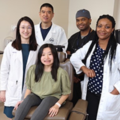 NIDCR clinical team poses with a patient.